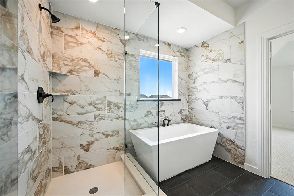 4520 Script Street Prosper, TX 75078 - Photo 18 of 27 a bathroom with a bathtub and shower