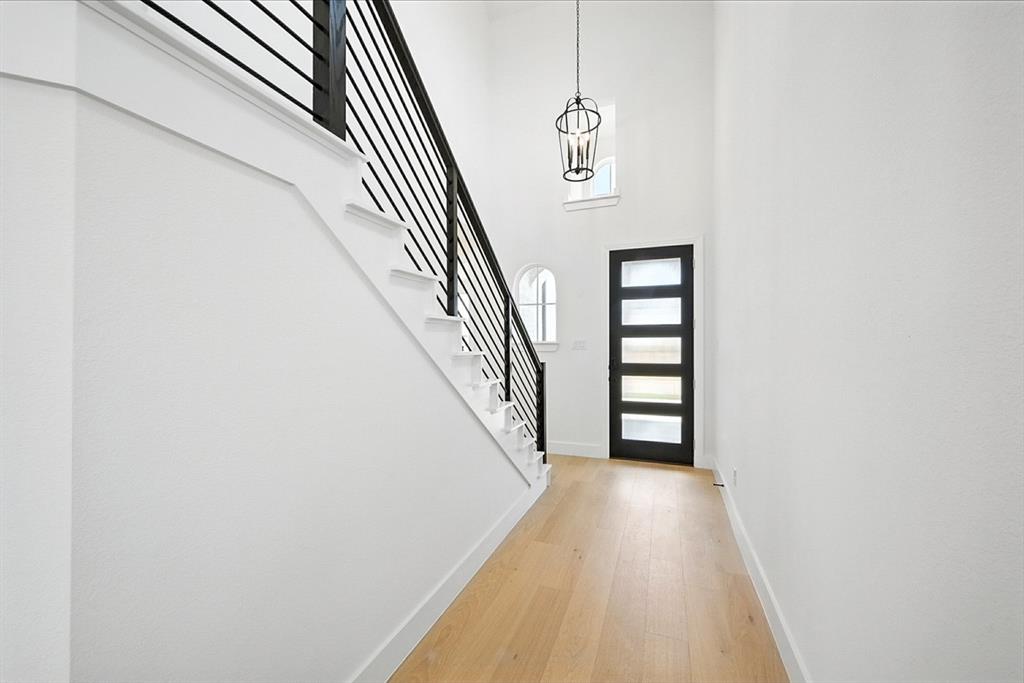 4520 Script Street Prosper, TX 75078 - Photo 20 of 27 a view of a hallway with wooden floor and staircase