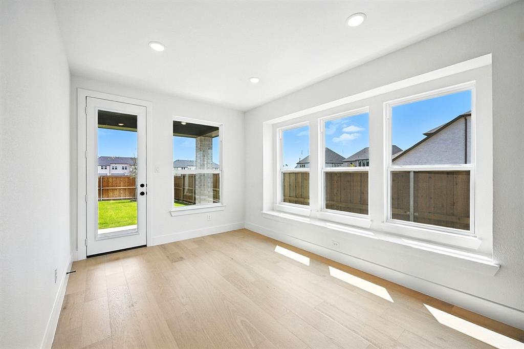 4520 Script Street Prosper, TX 75078 - Photo 21 of 27 a view of an empty room with a window and wooden floor
