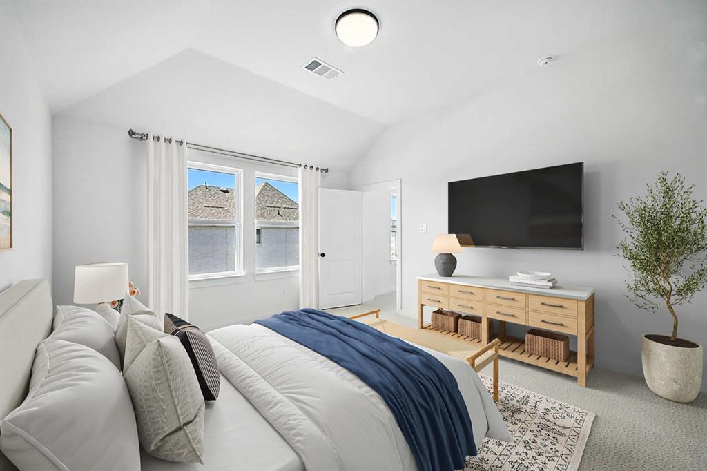 4520 Script Street Prosper, TX 75078 - Photo 4 of 27 a bedroom with a bed and a flat screen tv