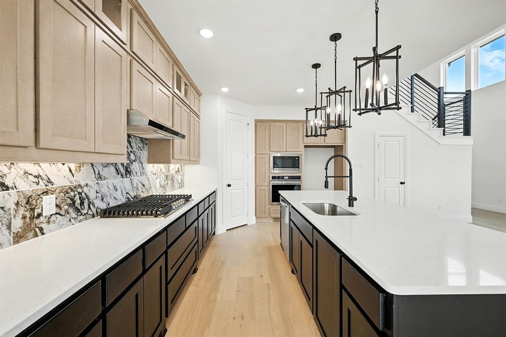 4520 Script Street Prosper, TX 75078 - Photo 7 of 27 a kitchen with stainless steel appliances a sink stove and cabinets