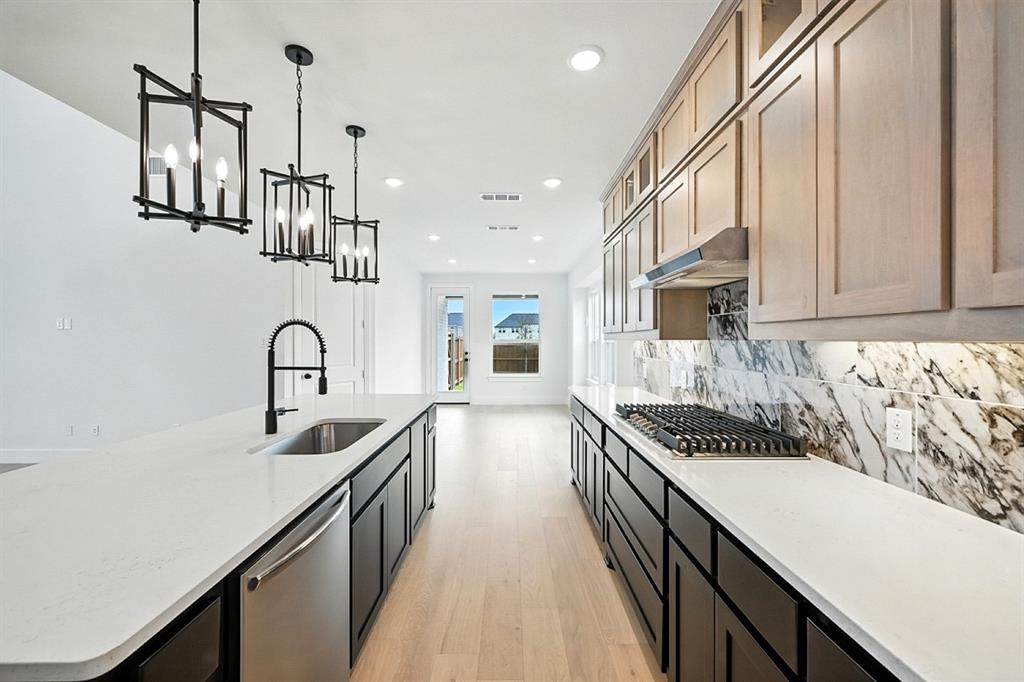 4520 Script Street Prosper, TX 75078 - Photo 10 of 27 a kitchen with stainless steel appliances a sink and stove