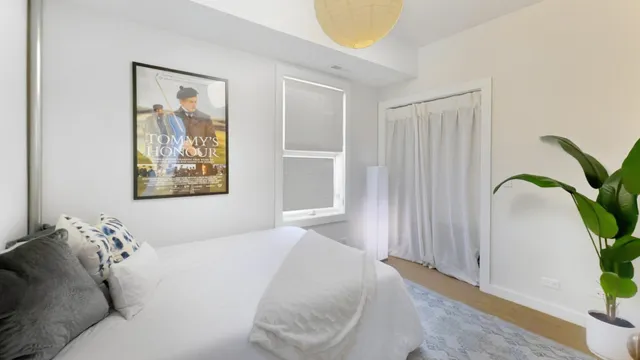 a bedroom with a bed and a painting on the wall