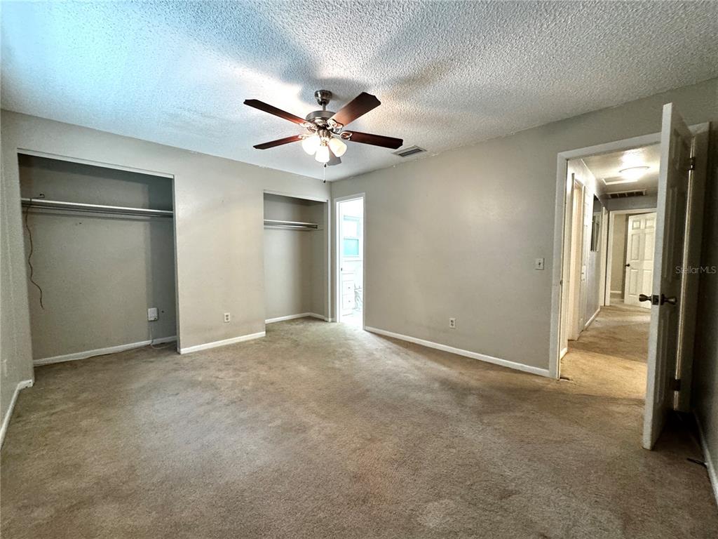 3419 Pearson Road Valrico, FL 33596 - Photo 12 of 20 an empty room with closet and a chandelier fan