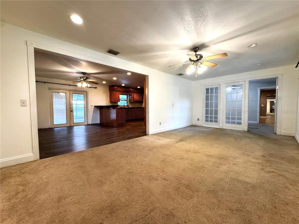 3419 Pearson Road Valrico, FL 33596 - Photo 3 of 20 an empty room with chandelier fan and windows