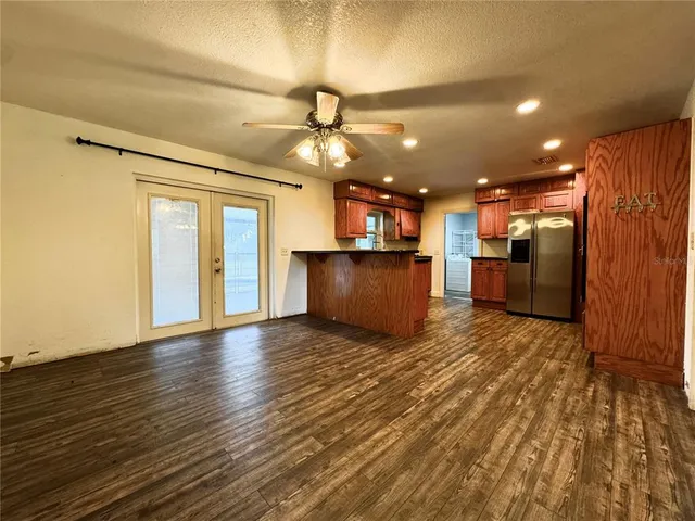 a view of an empty room with a kitchen