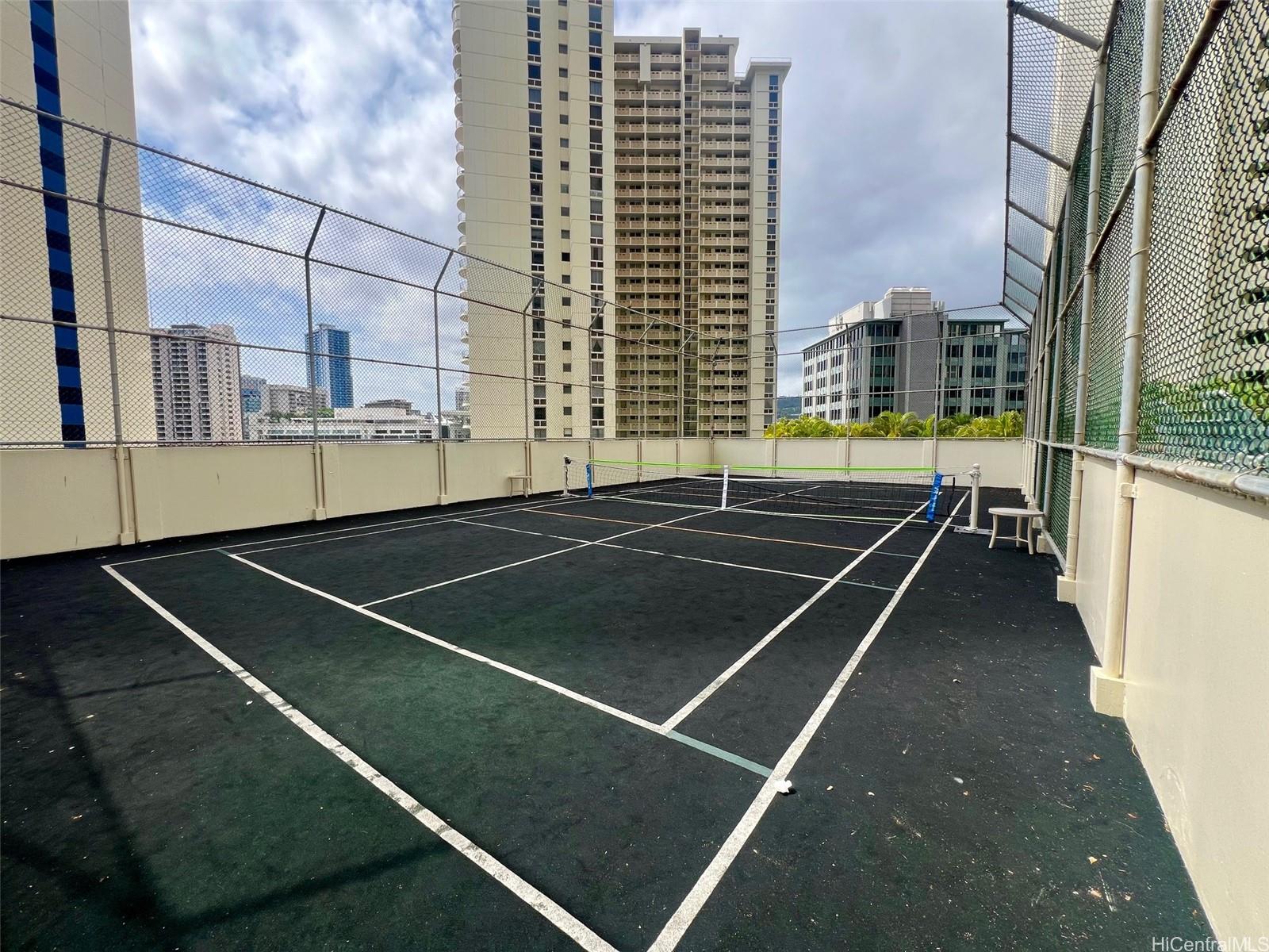 469 Ena Road, Unit 2010 Honolulu, HI 96815 - Photo 22 of 25 Pickleball/tennis court beside swimming pool and BBQ area on 7th level rec deck
