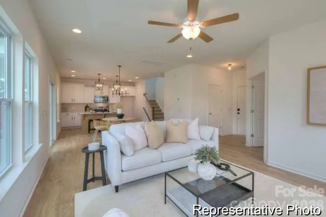 a living room with furniture and kitchen view