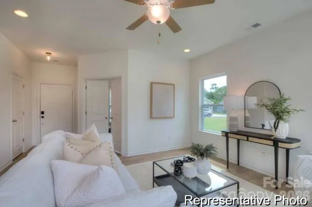 a living room with furniture and a potted plant