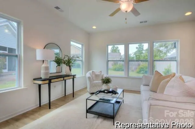 a living room with furniture and a large window