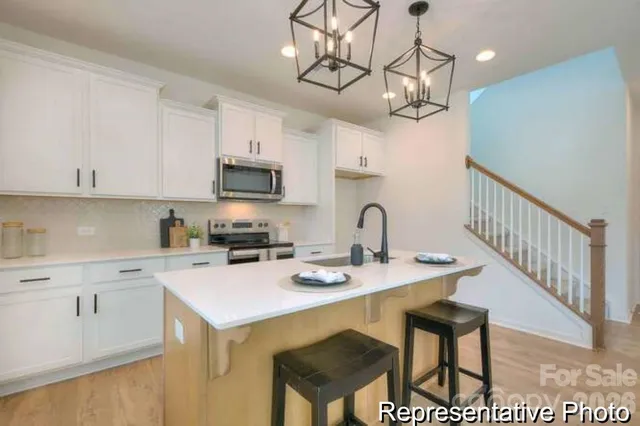 a kitchen with a table chairs and microwave