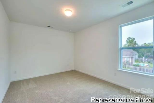 a view of a hallway with an empty room and window