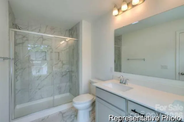 a bathroom with a sink a toilet and mirror