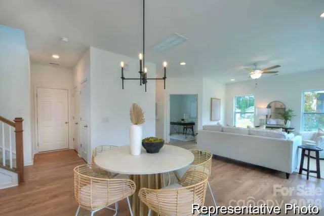 a living room with furniture a window and kitchen view