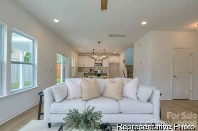 a living room with furniture and a large window