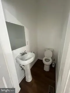 a white toilet sitting next to a bathroom sink