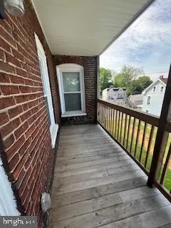 a view of a balcony with wooden floor