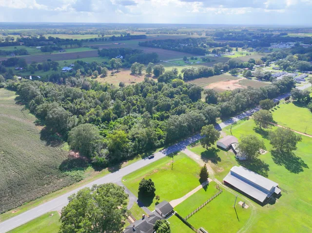 an aerial view of a house with a yard