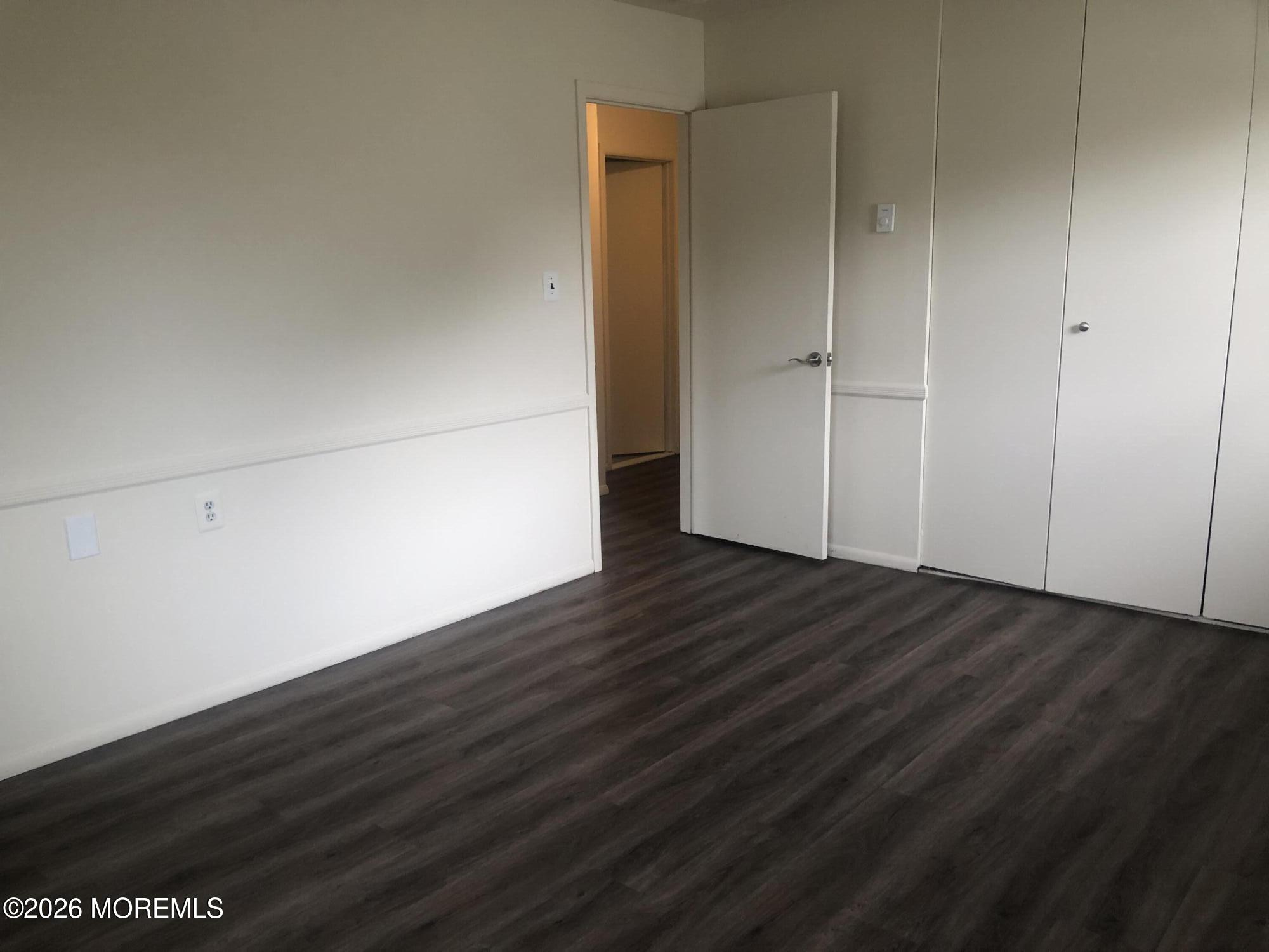 6 Dickinson Road Brick, NJ 08724 - Photo 14 of 17 an empty room with wooden floor