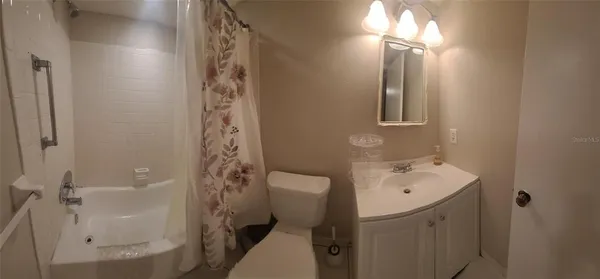 a kitchen with a stove and white cabinets