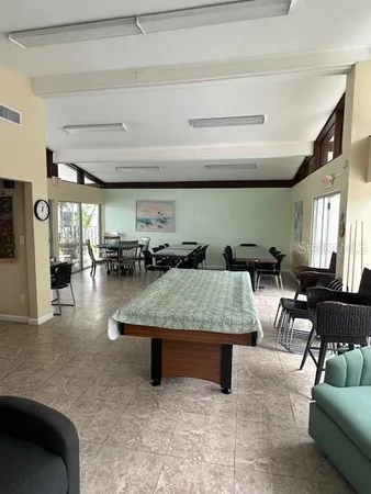 a view of a house with swimming pool and sitting area