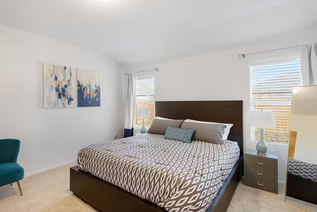 3609 Batson Drive Austin, TX 78725 - Photo 20 of 33 Bedroom with light colored carpet and baseboards