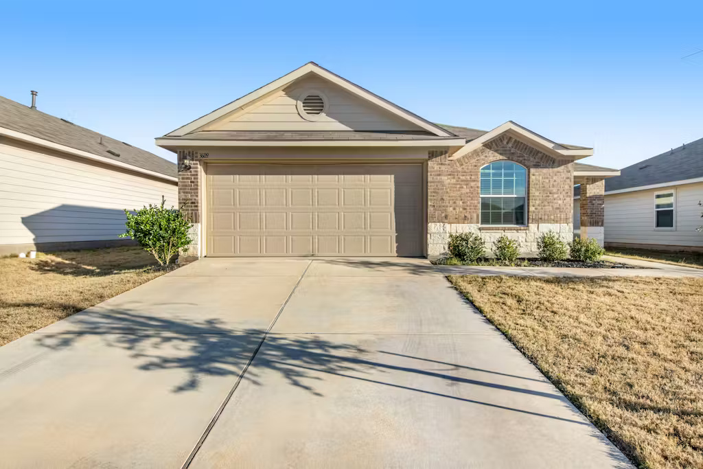 3609 Batson Drive Austin, TX 78725 - Photo 24 of 33 Ranch-style home featuring brick siding, concrete driveway, and a garage