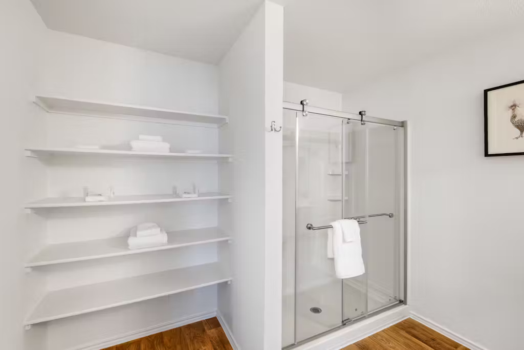 3609 Batson Drive Austin, TX 78725 - Photo 26 of 33 Bathroom with dark wood-style floors and a shower stall