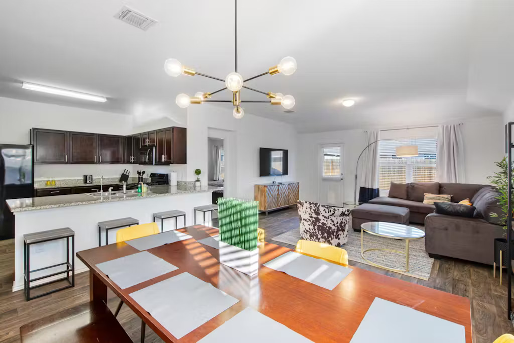 3609 Batson Drive Austin, TX 78725 - Photo 4 of 33 Dining room with dark wood finished floors and a chandelier