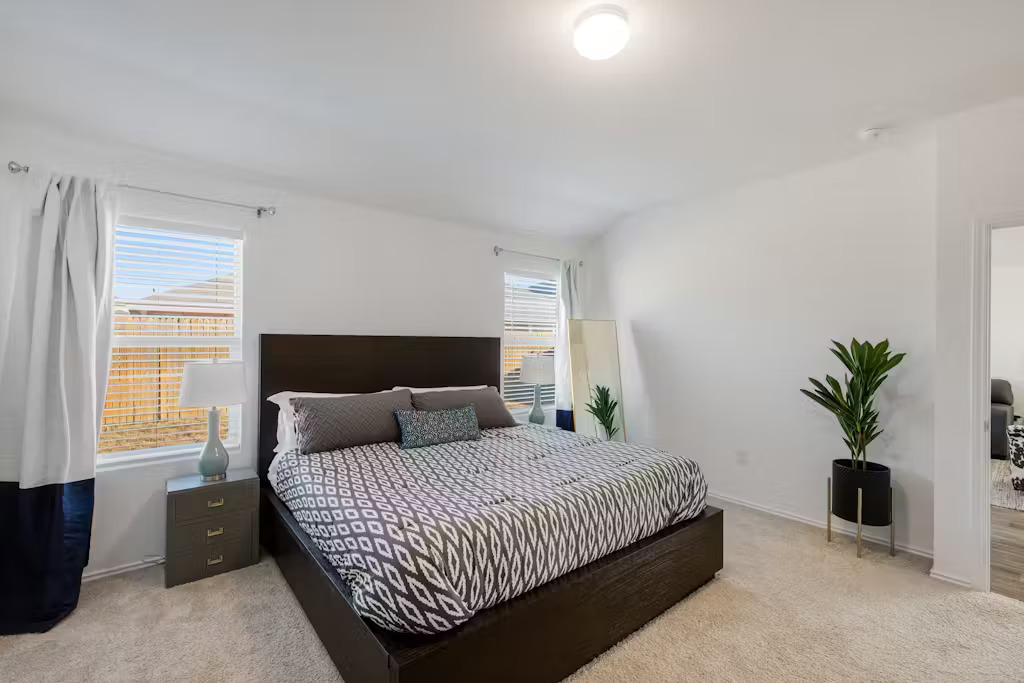 3609 Batson Drive Austin, TX 78725 - Photo 8 of 33 Bedroom featuring light carpet and baseboards