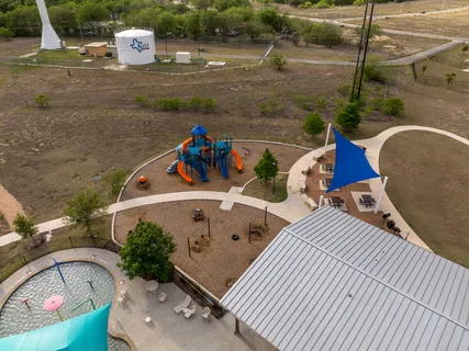 an aerial view of a swimming pool a yard and outdoor seating