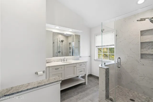 a bathroom with a double vanity sink toilet mirror and bathtub