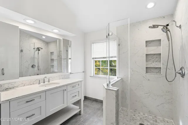 a spacious bathroom with a granite countertop sink a toilet and shower