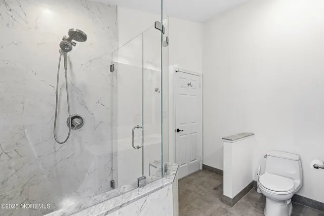 a bathroom with a shower and toilet