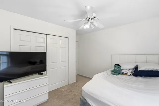 a bedroom with a bed and a flat tv screen