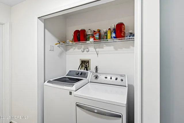 a utility room with dryer washer and shoe rack