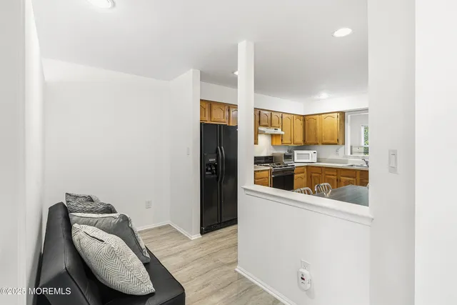 a kitchen with a refrigerator sink and cabinets