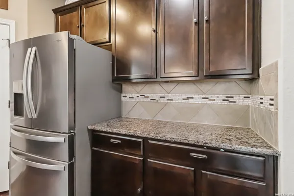 a kitchen with granite countertop stainless steel appliances and cabinets