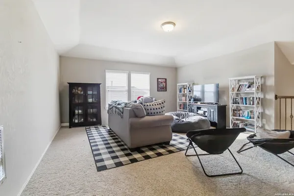 a living room with furniture and a book shelf