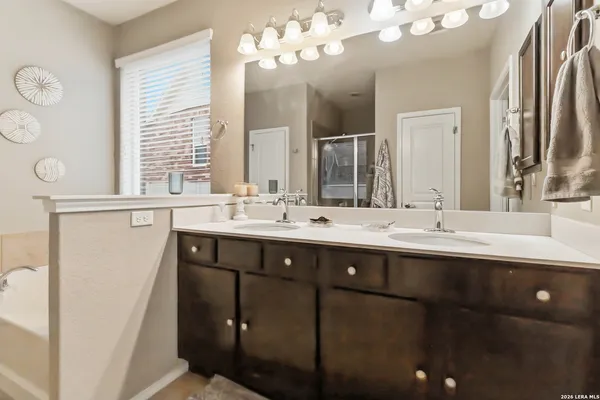 a bathroom with a sink double vanity and a mirror