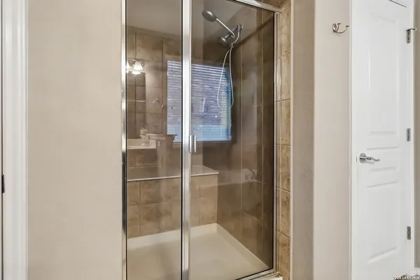 a bathroom with a glass shower door