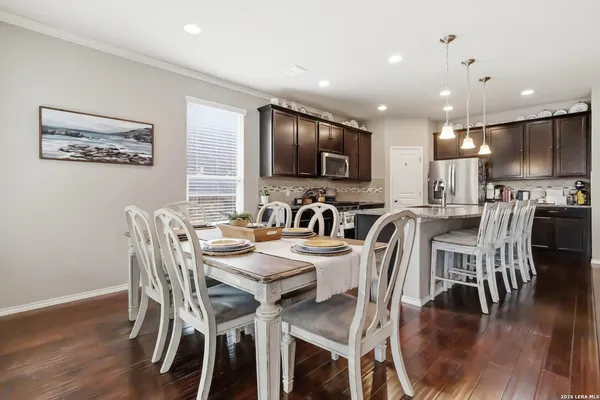 a view of a dining area with furniture and wooden floor