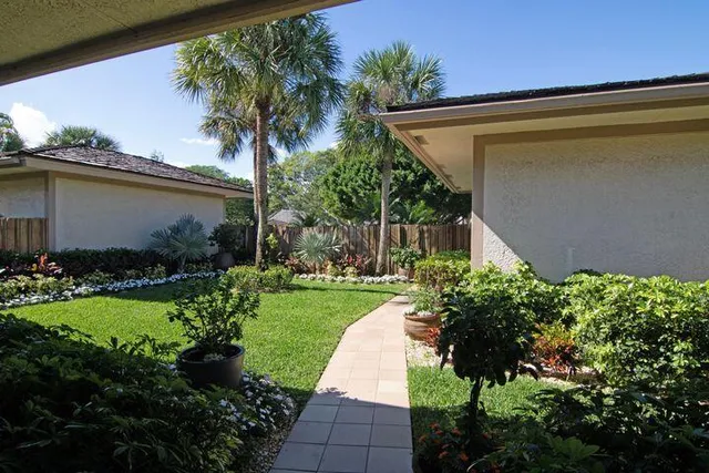 a view of a backyard with plants and a patio