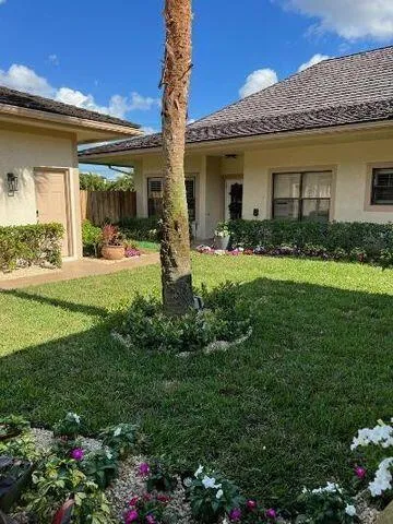 a view of a house with garden and porch