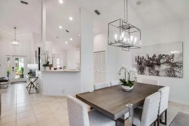 a view of a dining room with furniture and chandelier