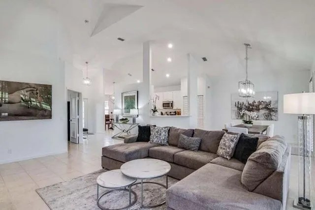 a living room with furniture and a chandelier
