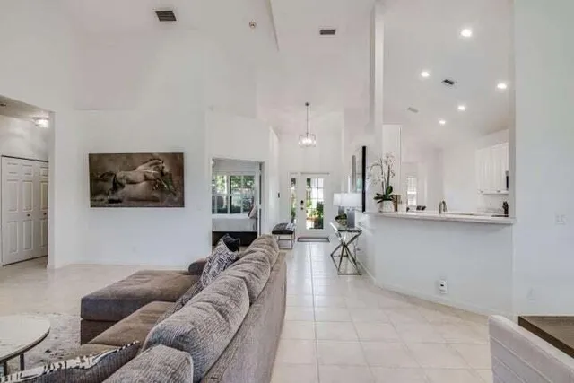a living room with furniture and a painting on the wall