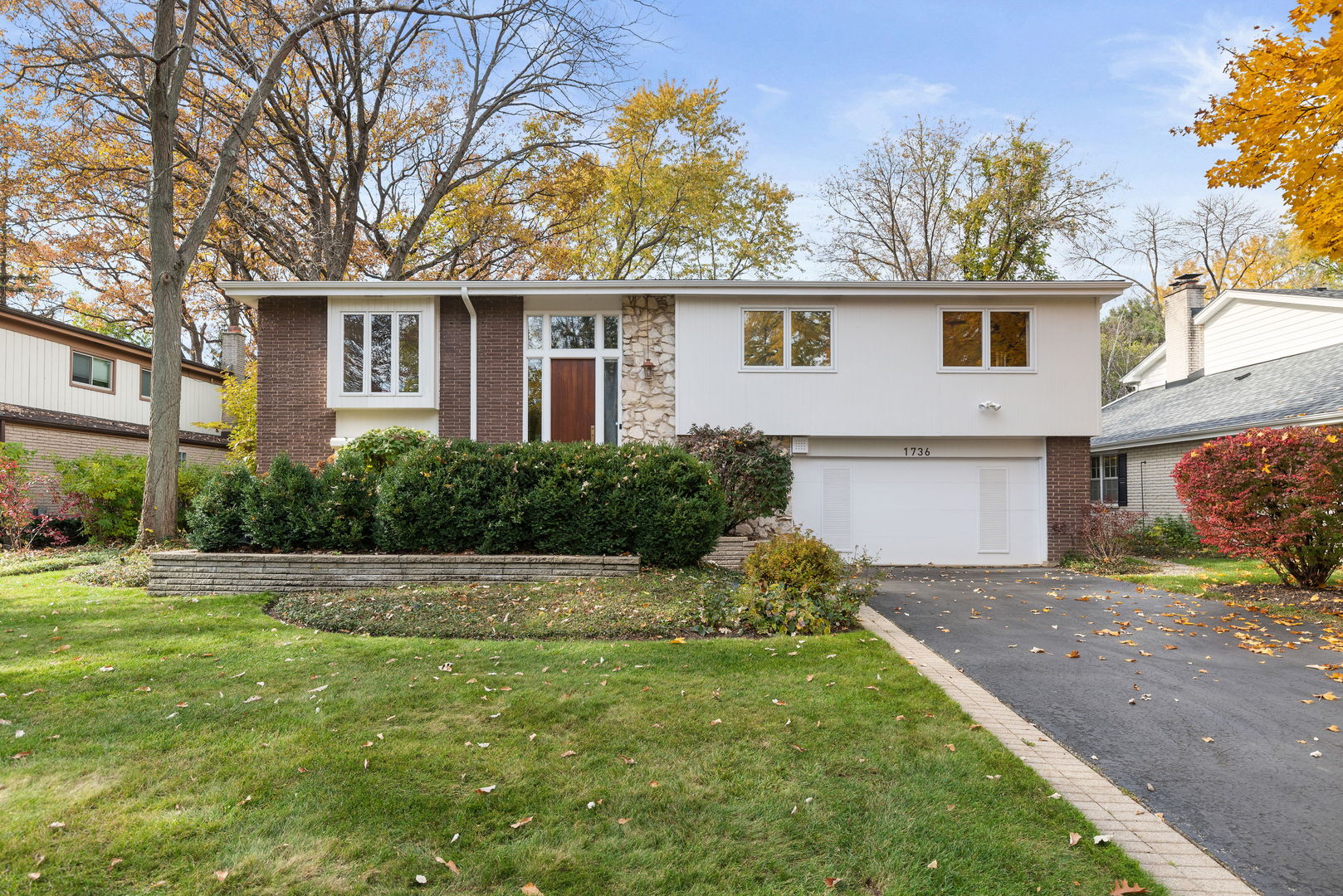 1736 Cavell Avenue Highland Park, IL 60035 - Photo 1 of 29 a front view of a house with a garden and yard