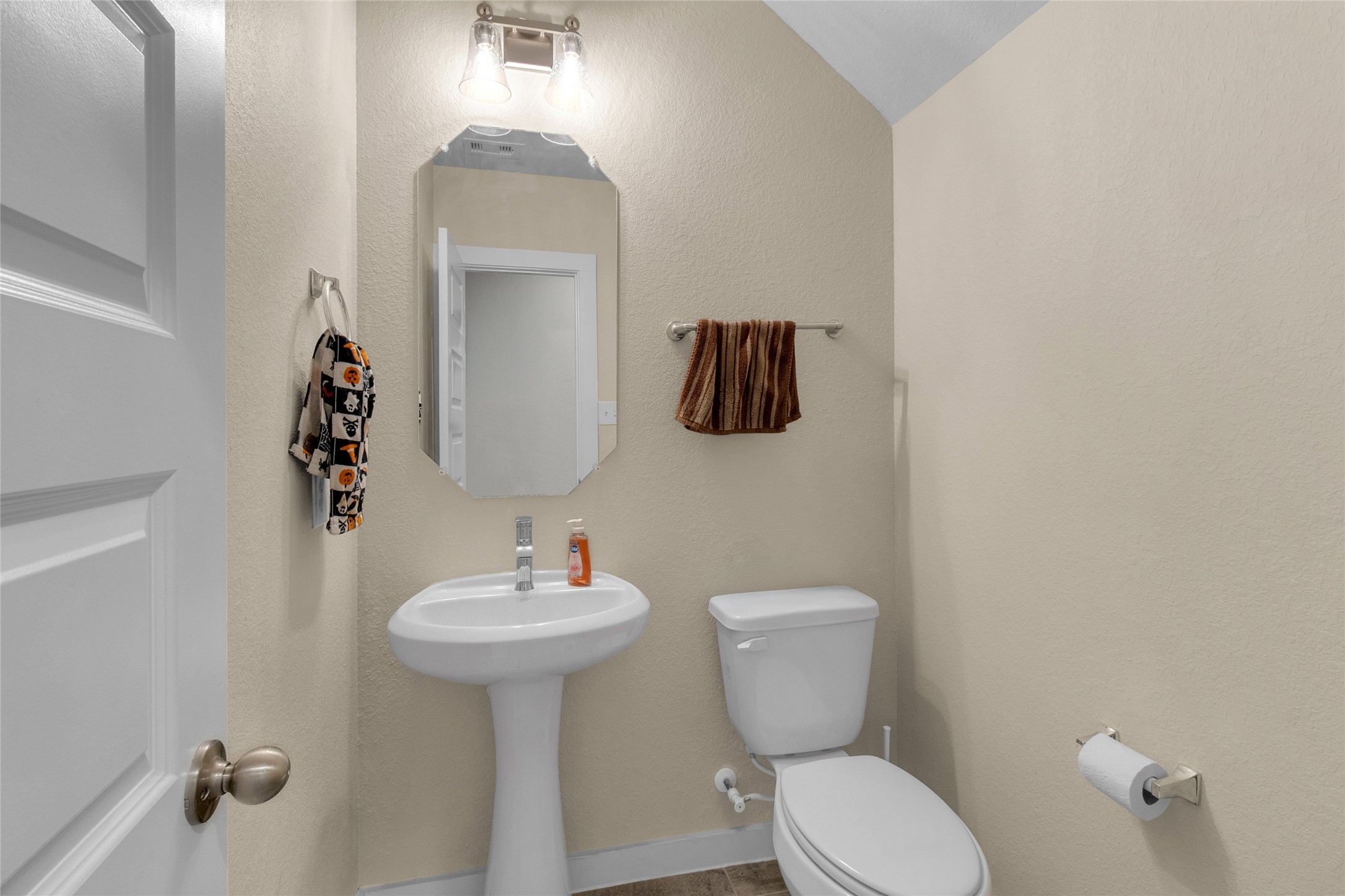 2314 Village Side Trail Rosenberg, TX 77471 - Photo 13 of 31 a bathroom with a toilet sink and mirror