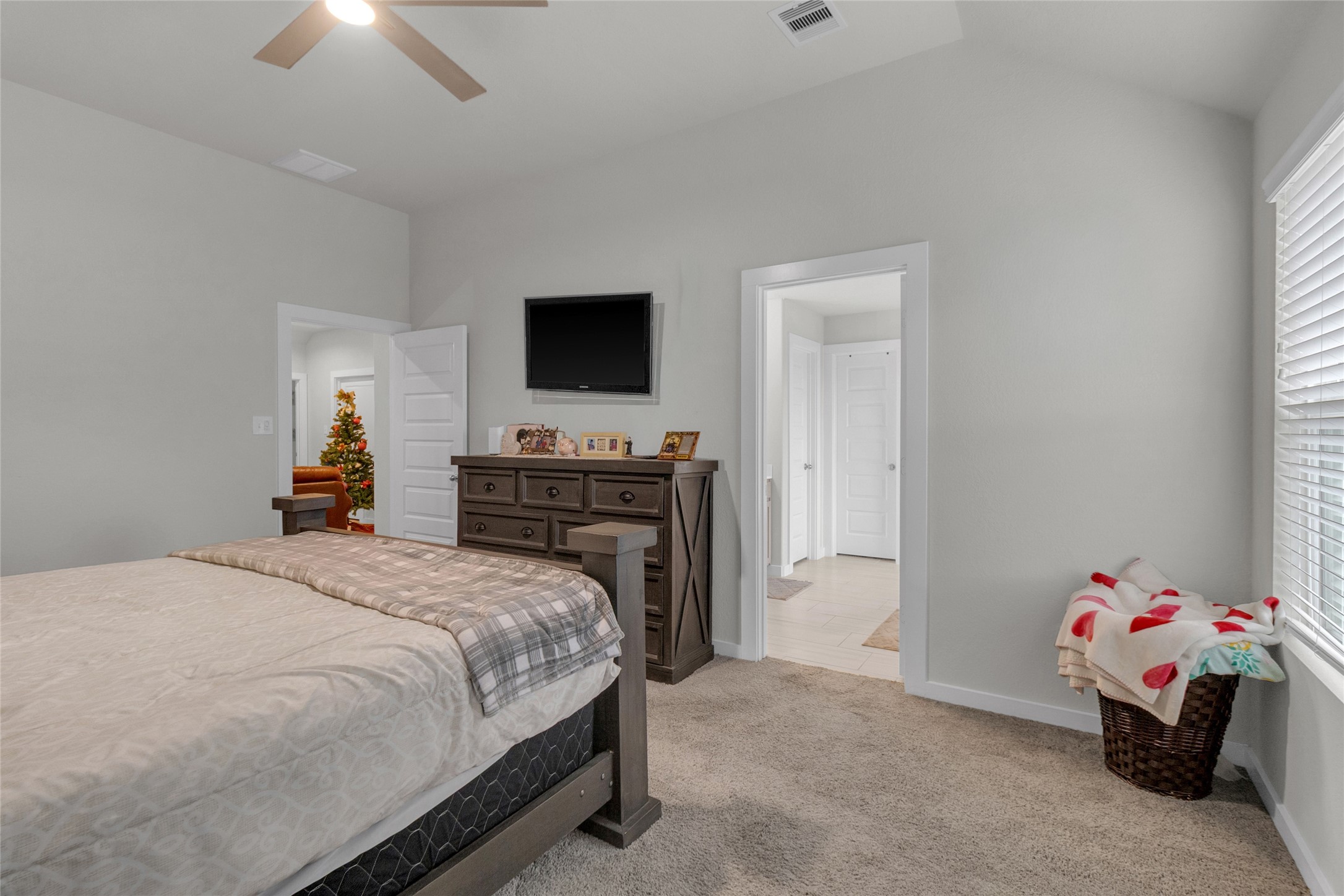 2314 Village Side Trail Rosenberg, TX 77471 - Photo 19 of 31 a bedroom with a bed and a chandelier